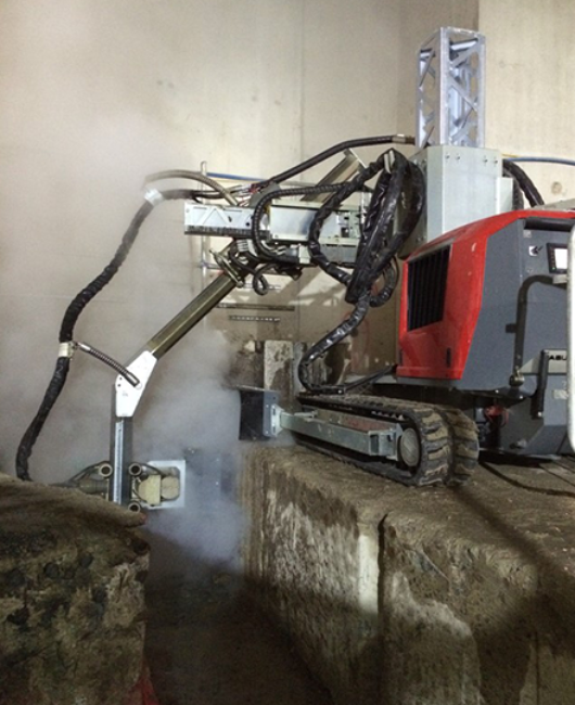Hydrodemolition-robot-tackles-concrete-hydroblasting-with-over-edge-arm-attachement.png